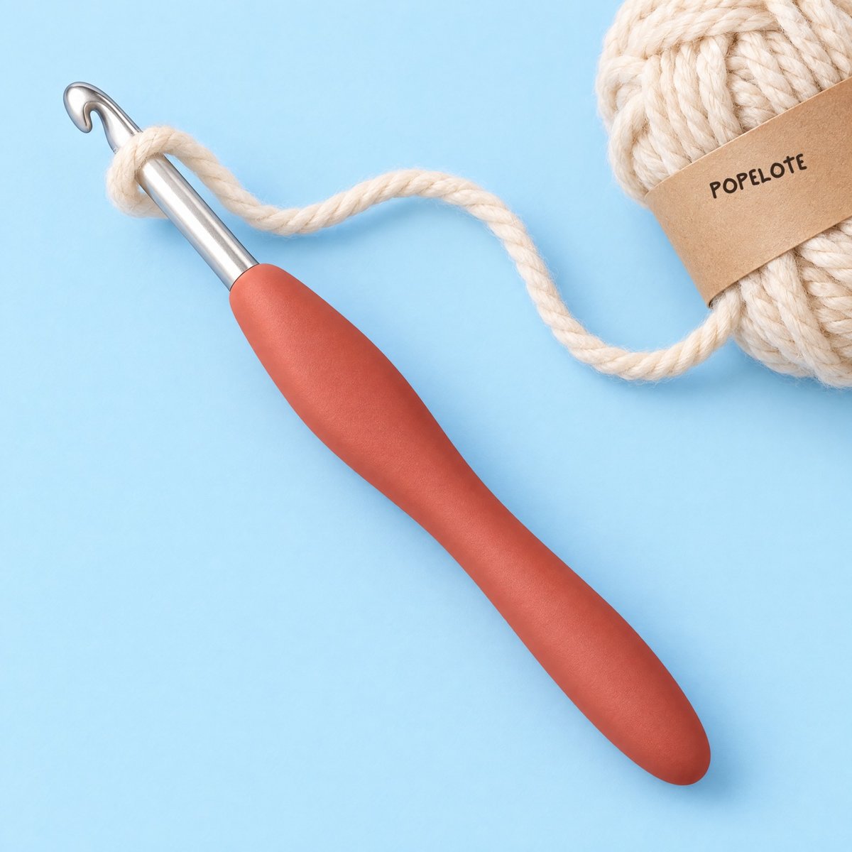The Popelote hook with its coral handle, and yarn